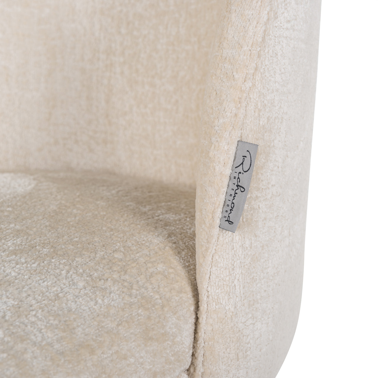 Contemporary dining chair in cream upholstery with black and gold legs