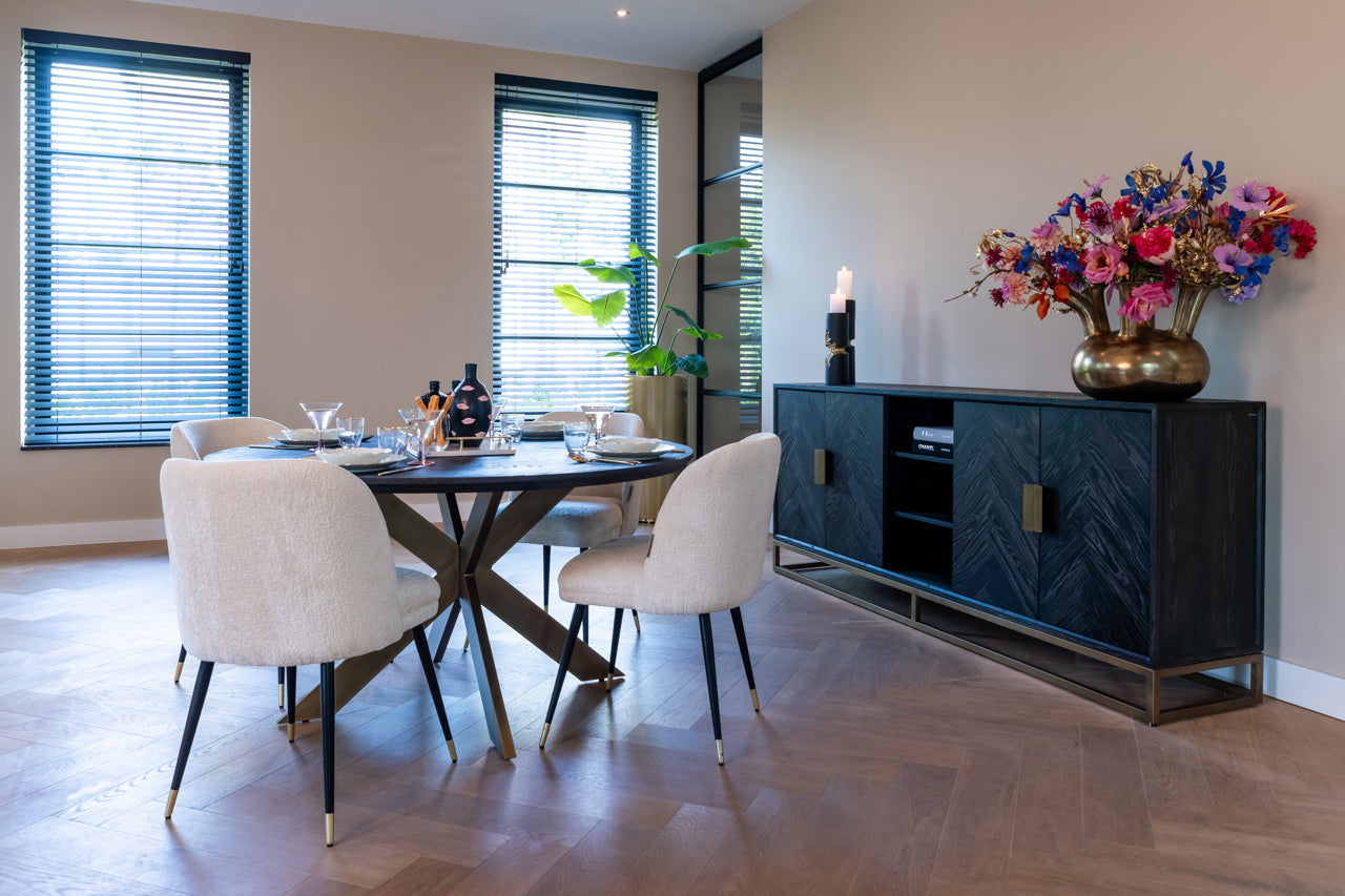 Contemporary dining chair in cream upholstery with black and gold legs
