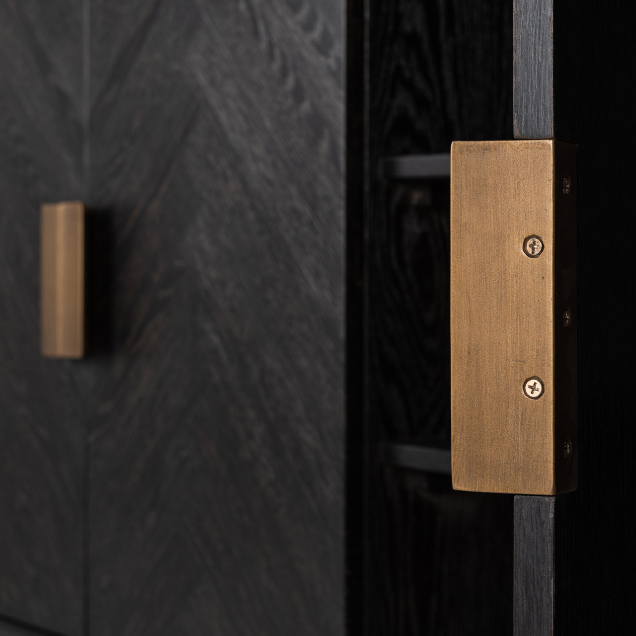Modern black wood sideboard cabinet with brass handles and storage shelves.