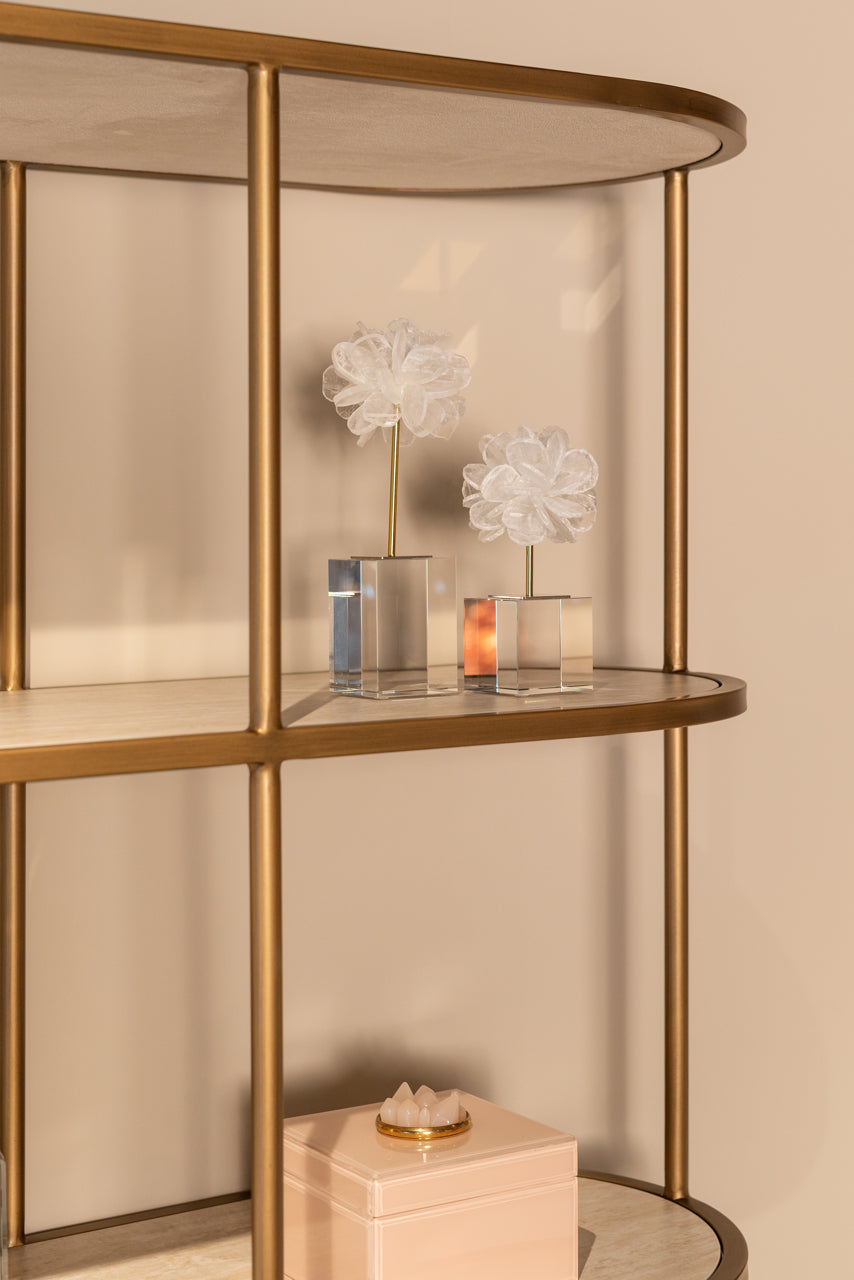 Modern display cabinet with ceramic top, open shelving and gold metal frame.