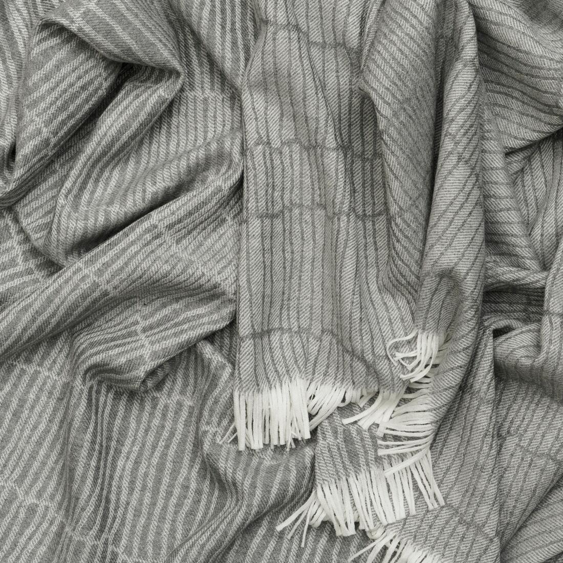 Andrew Martin tan Merino wool throw with geometric pattern and fringe