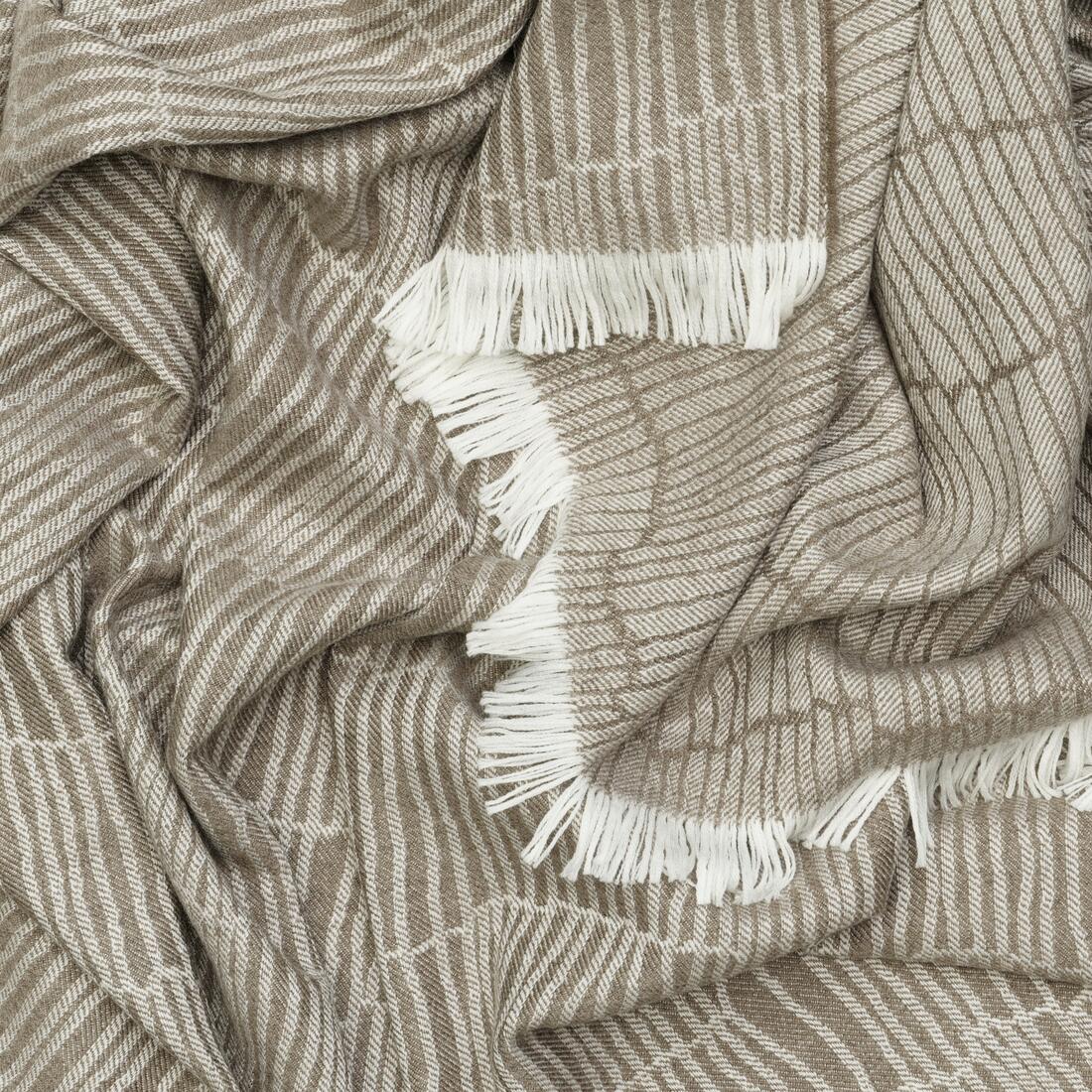 Andrew Martin tan Merino wool throw with geometric pattern and fringe