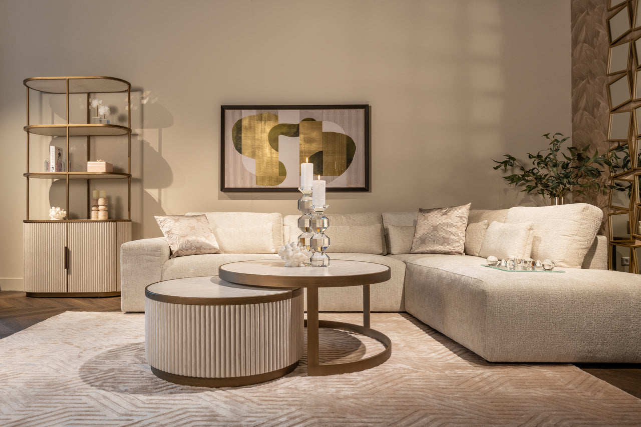 Modern display cabinet with ceramic top, open shelving and gold metal frame.