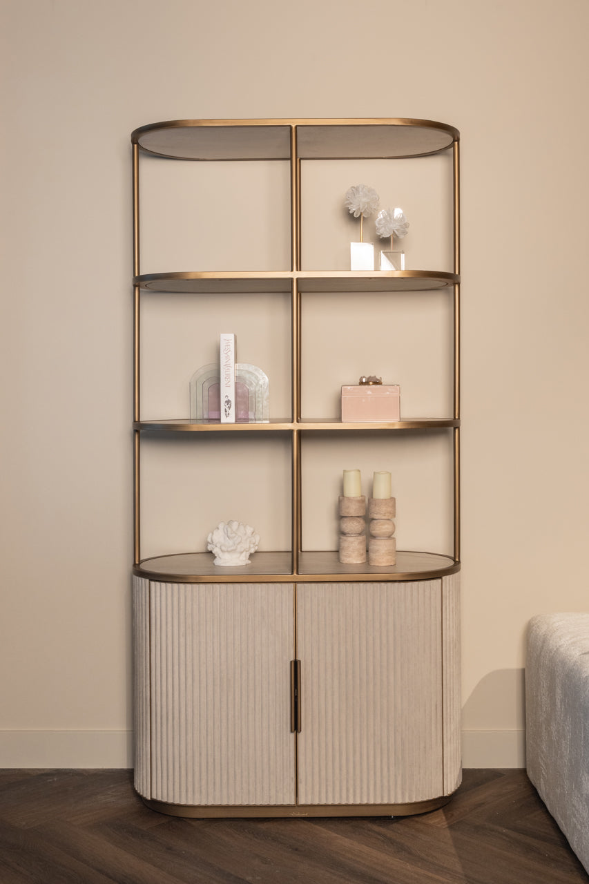 Modern display cabinet with ceramic top, open shelving and gold metal frame.