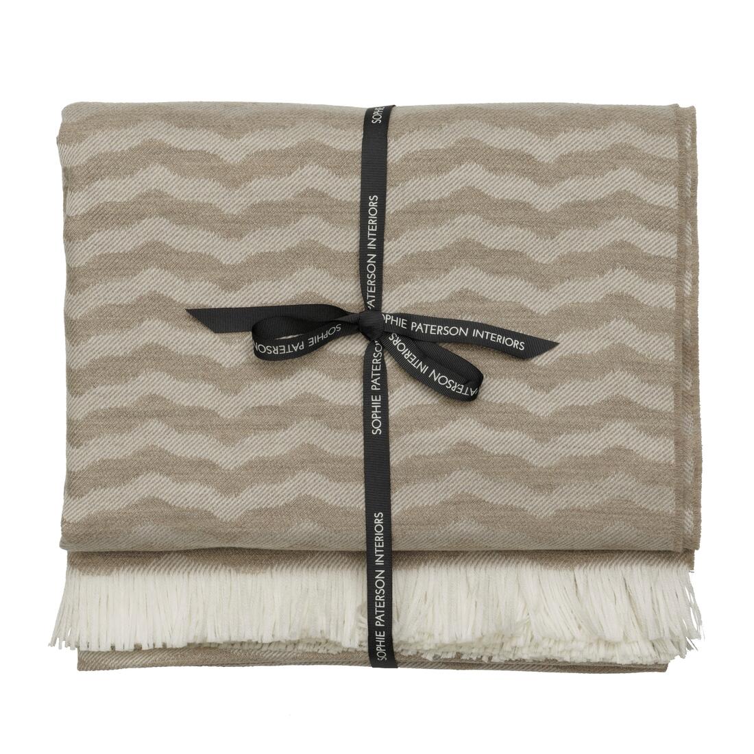 Andrew Martin tan Merino wool throw with geometric pattern and fringe