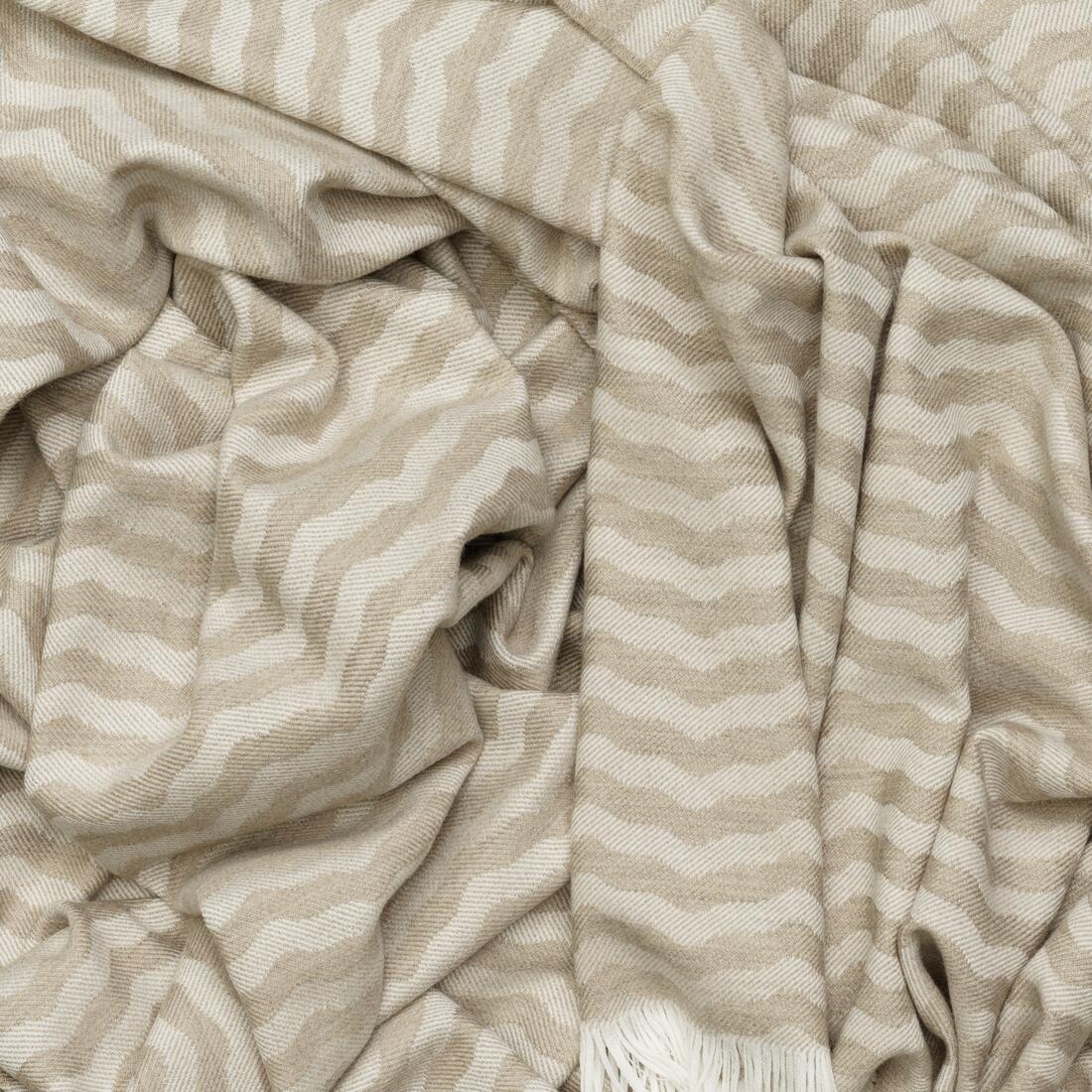 Andrew Martin tan Merino wool throw with geometric pattern and fringe