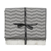 Andrew Martin tan Merino wool throw with geometric pattern and fringe
