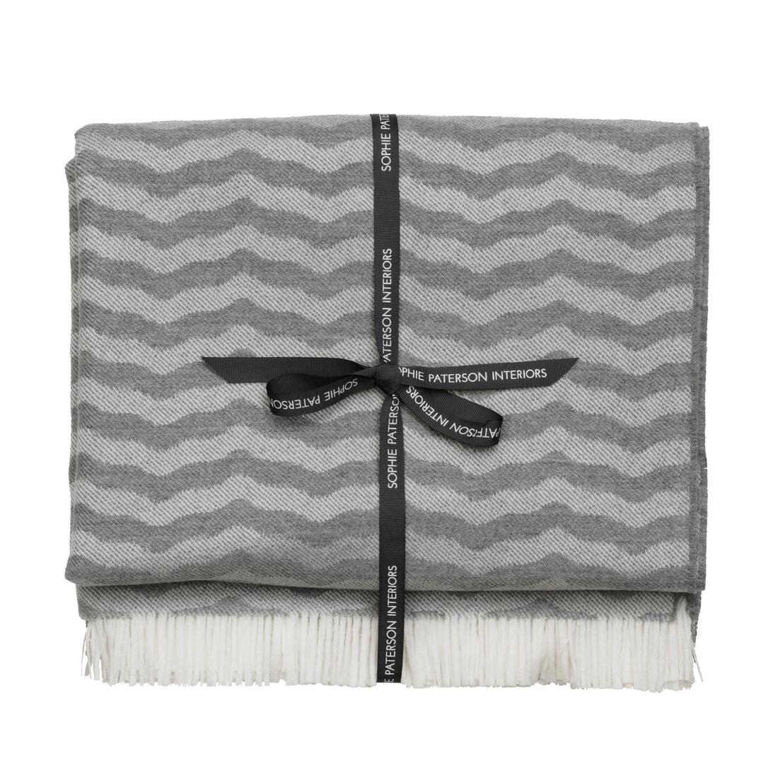 Andrew Martin tan Merino wool throw with geometric pattern and fringe