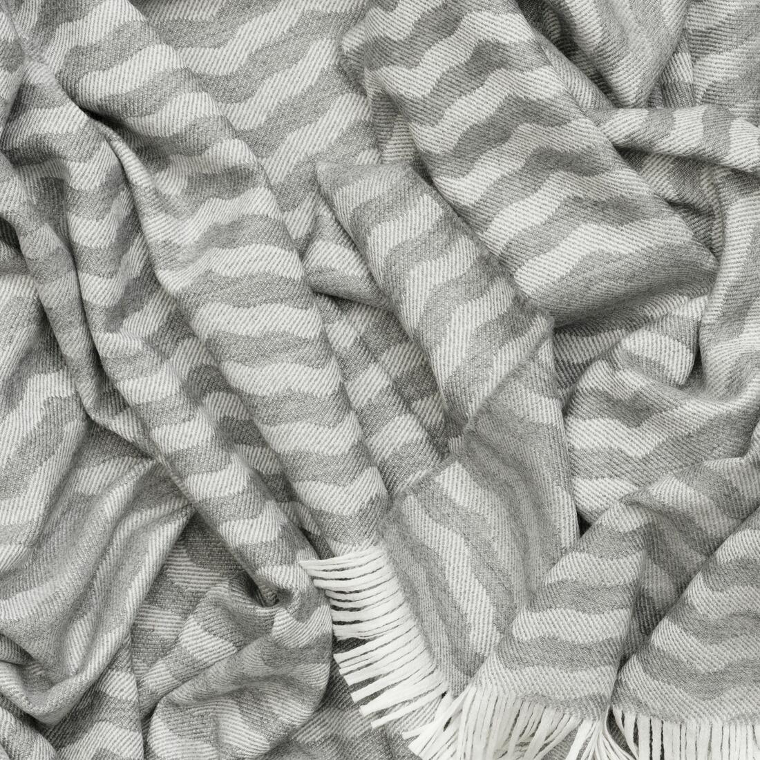 Andrew Martin tan Merino wool throw with geometric pattern and fringe