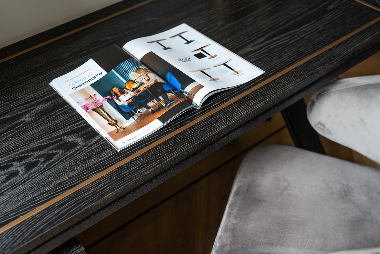 Contemporary black wood desk with brass accents and drawer storage