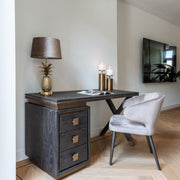 Contemporary black wood desk with brass accents and drawer storage