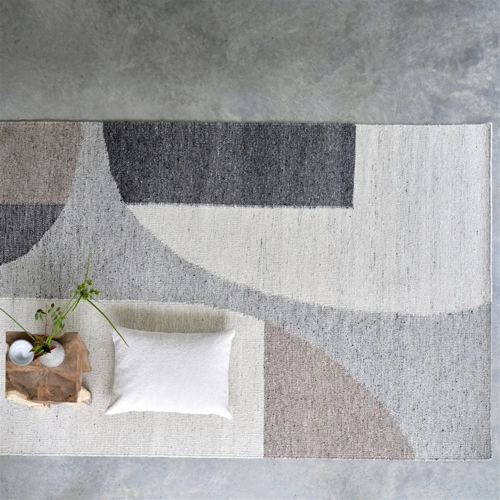 Neutral abstract geometric rug in ivory, taupe and beige with soft curved shapes, modern handwoven area rug.