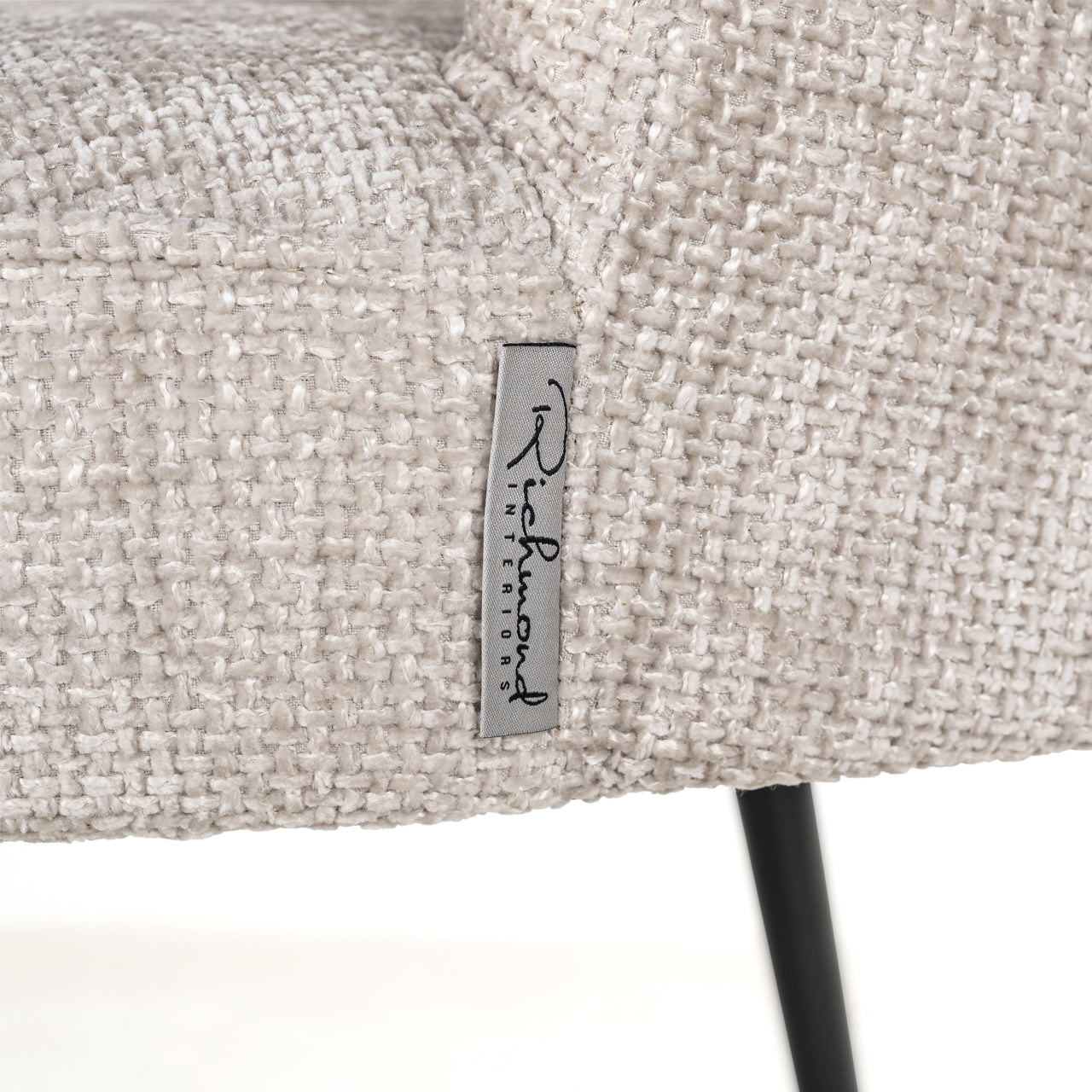 Contemporary upholstered dining chair in neutral fabric with black legs