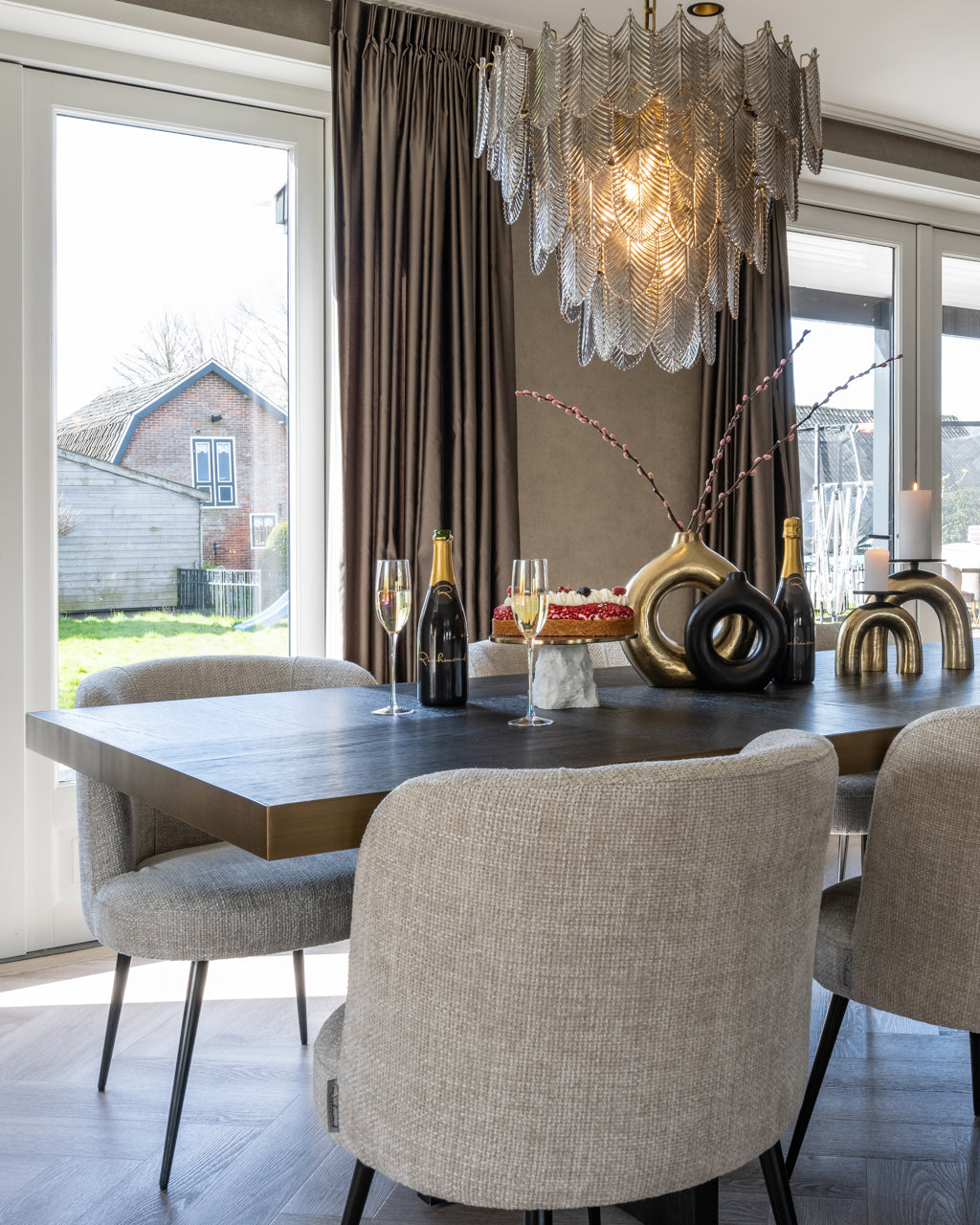 Contemporary upholstered dining chair in neutral fabric with black legs