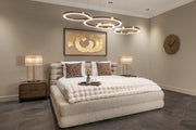 Beige upholstered storage bed with padded headboard and lift-up ottoman base