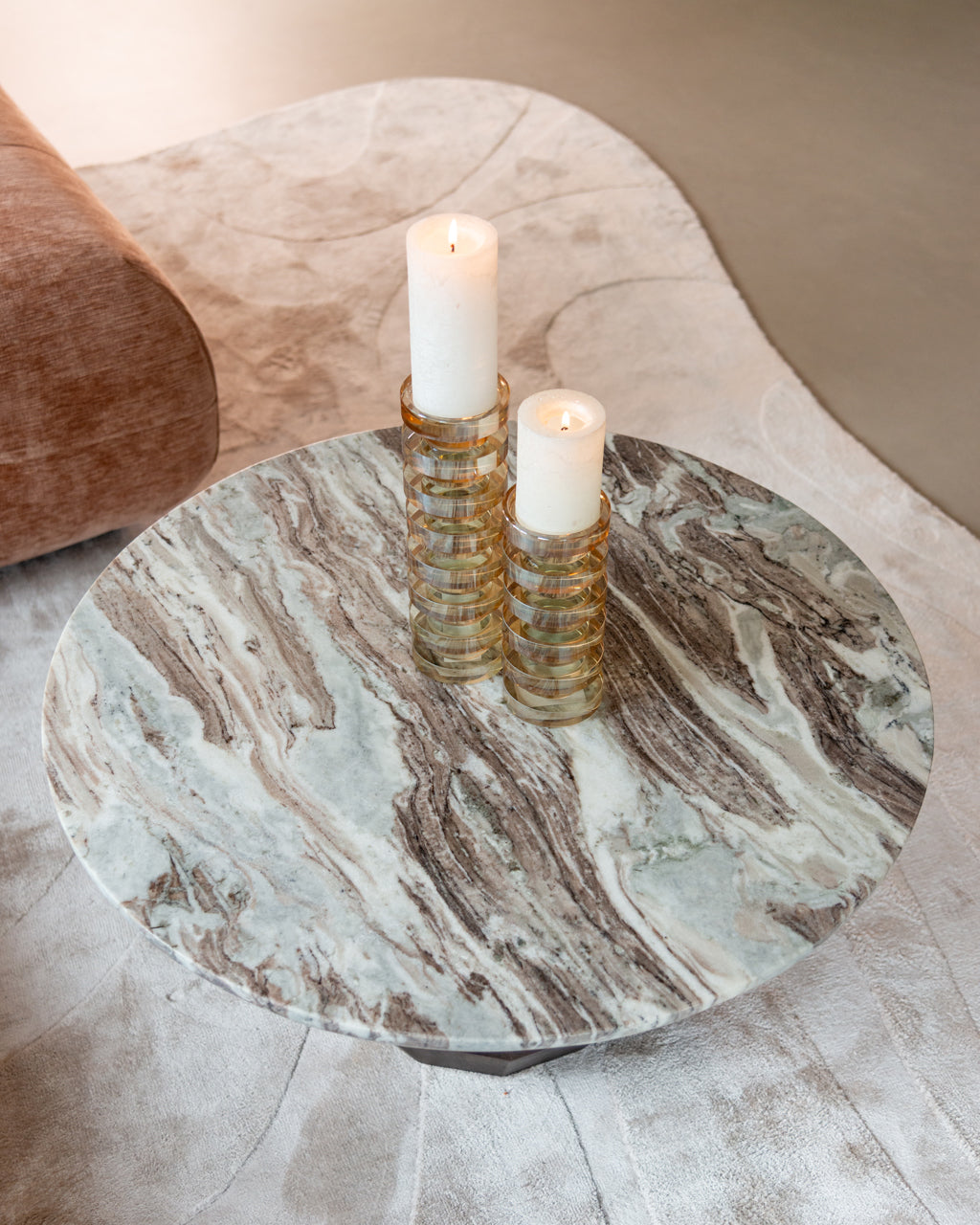 Round marble coffee table with dark mango wood base, modern sculptural design