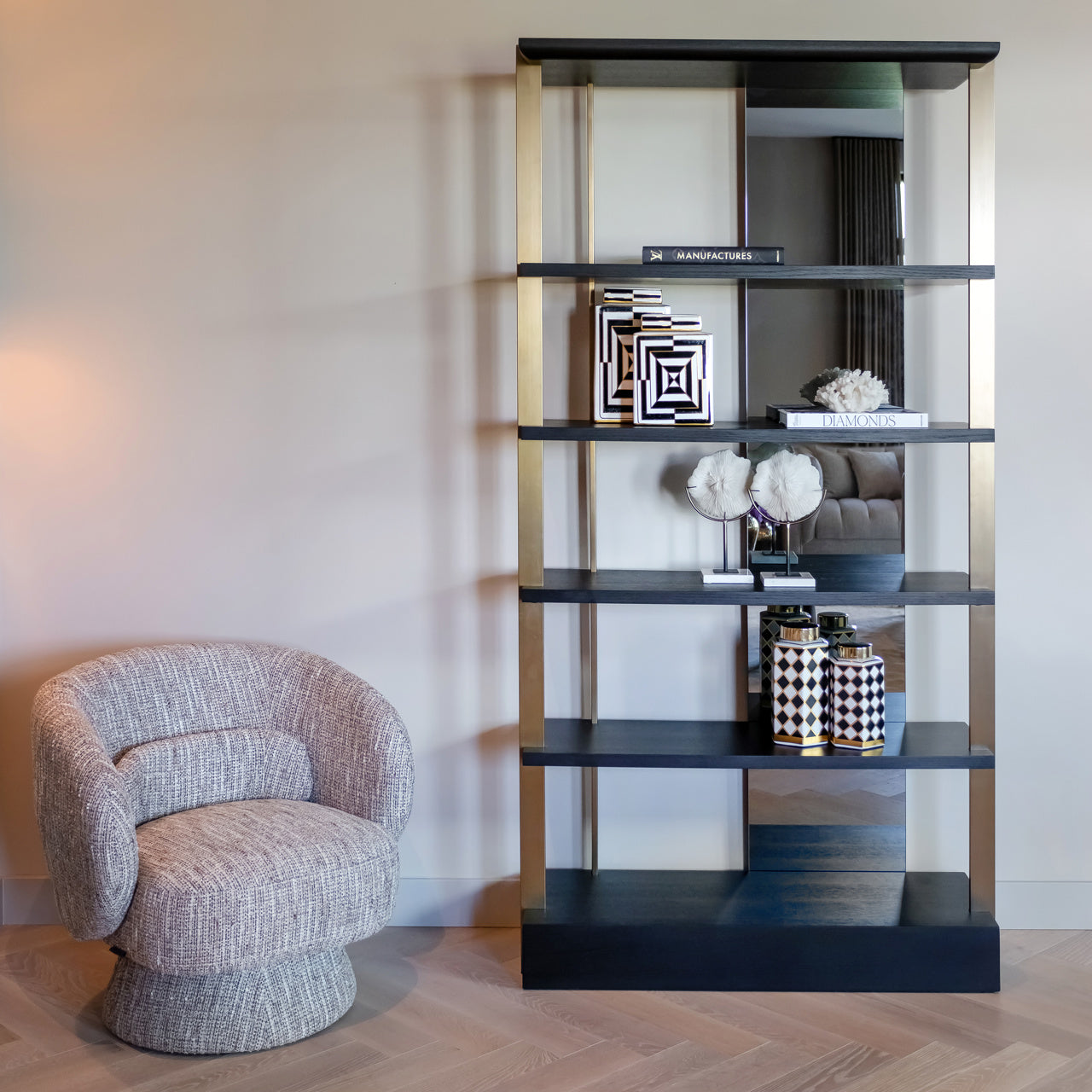 Modern wall shelving unit with mirror back gold frame and dark wood shelves