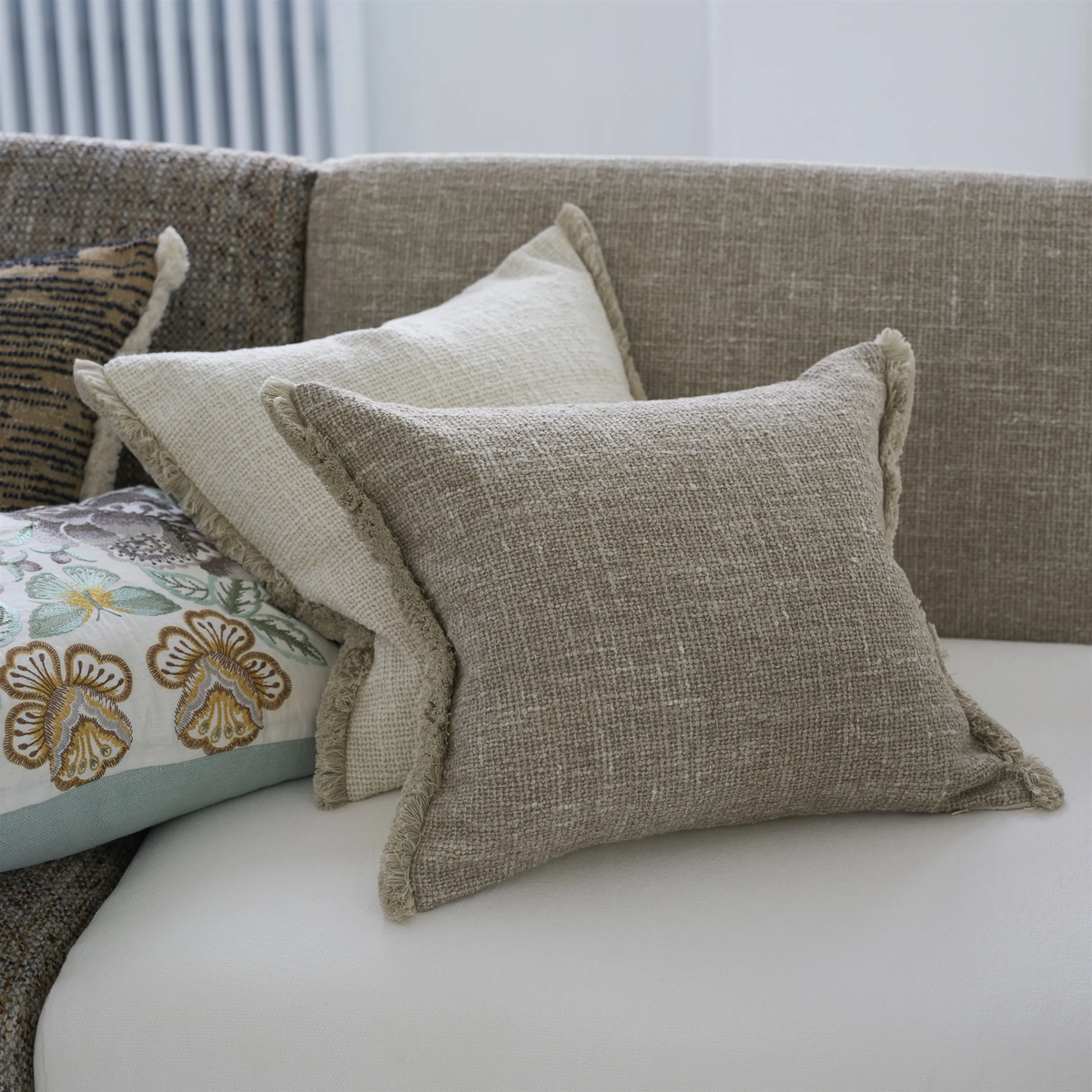 Ivory and sand boucle cushion with fringe 