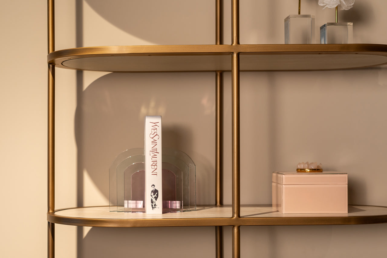 Modern display cabinet with ceramic top, open shelving and gold metal frame.
