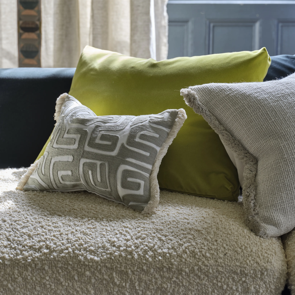 Sepia geometric embroidered cushion with fringe trim.