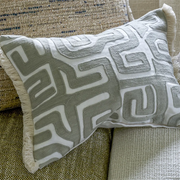 Sepia geometric embroidered cushion with fringe trim.