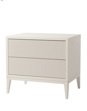 Wide white bedside table with ribbed drawer fronts