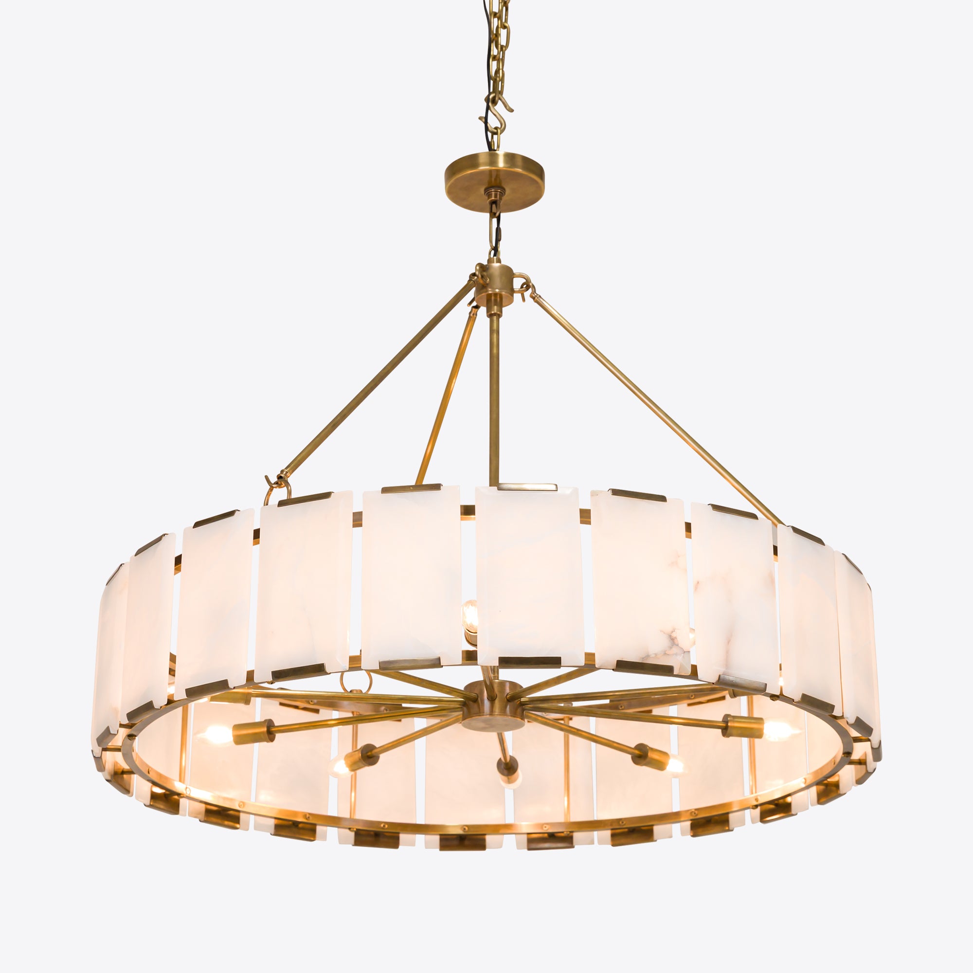 Luxury brass alabaster chandelier with circular frame and natural stone panels.