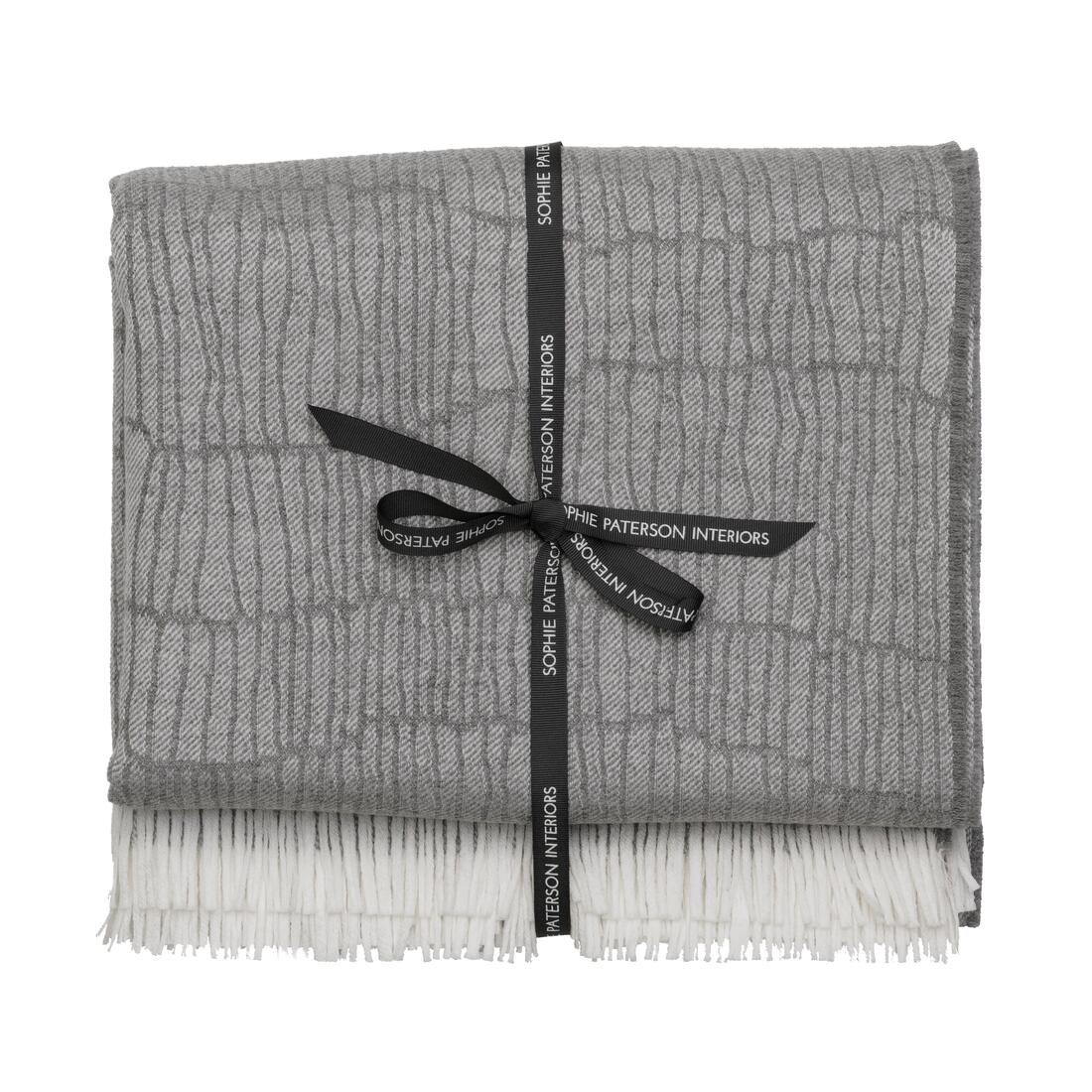 Andrew Martin tan Merino wool throw with geometric pattern and fringe
