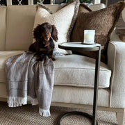 Andrew Martin tan Merino wool throw with geometric pattern and fringe